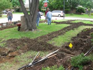 a fully trenched yard with lines being laid